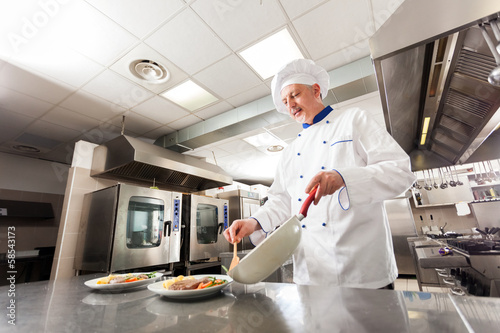 Photo: Chef working in his kitchen Chef working in his kitchen