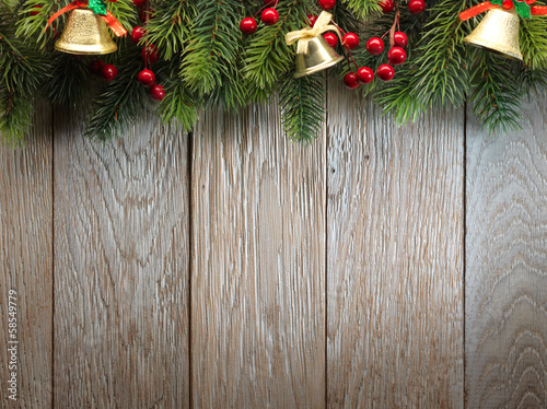Photo: Christmas fir tree on wood texture. background old panels Christmas fir tree on wood texture. background old panels
