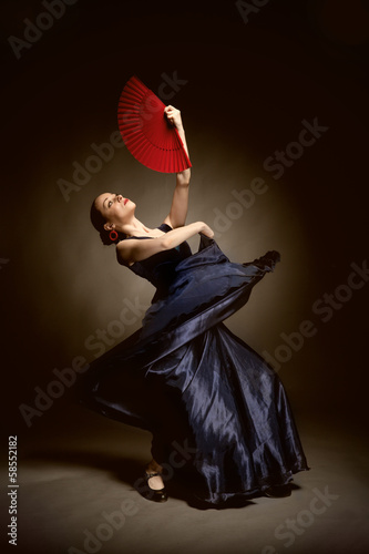 Photo: young woman dancing flamenco on black young woman dancing flamenco on black