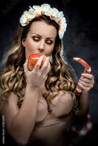 Photo: Sexy beautiful woman with red apple and snake Sexy beautiful woman with red apple and snake