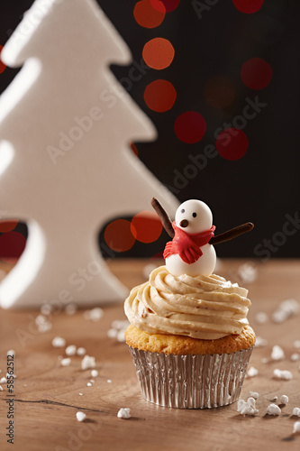 Photo: Snowman cupcake on Christmas background Snowman cupcake on Christmas background