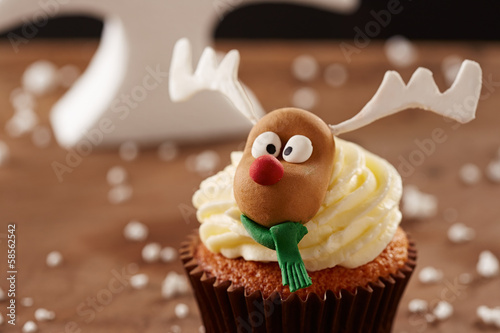 Photo: Rudolph reindeer cupcake on Christmas background Rudolph reindeer cupcake on Christmas background