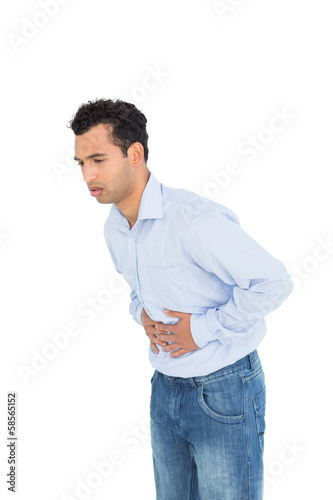 Photo: Casual young man with stomach pain Casual young man with stomach pain