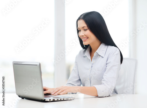 Photo: smiling businesswoman or student with laptop smiling businesswoman or student with laptop