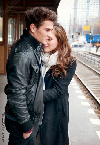 Photo: Young love couple waiting on the train stop Young love couple waiting on the train stop