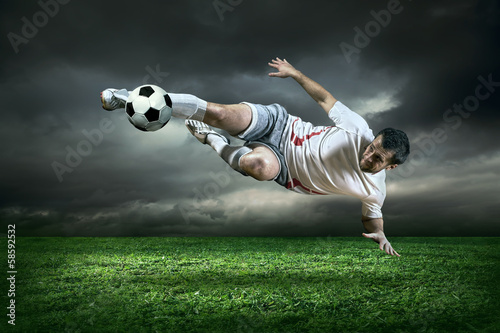  Football player with ball in action under rain outdoors