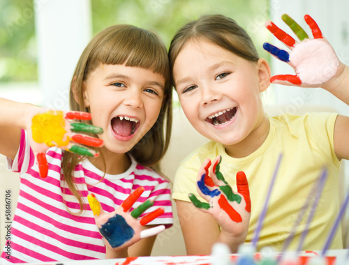 Photo: Little girls are painting with gouache Little girls are painting with gouache