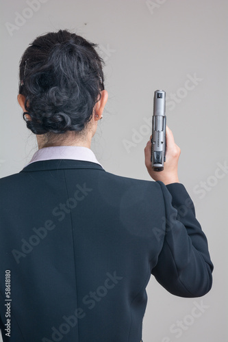 Photo: Woman holding a hand gun Woman holding a hand gun