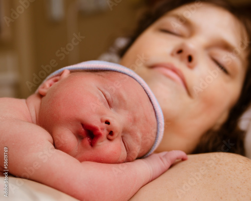 Mother and infant child resting after delivery at hospital