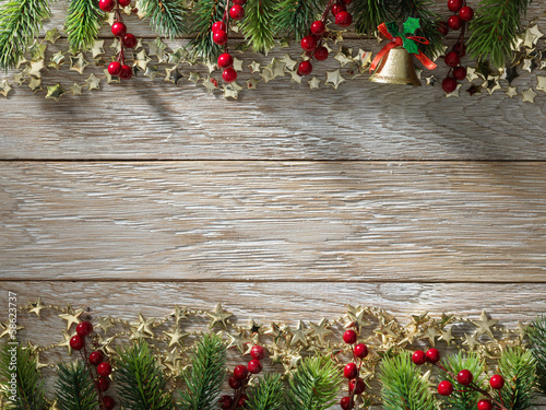 Photo: Christmas fir tree on wood texture. background old panels Christmas fir tree on wood texture. background old panels