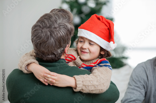 Photo: Son Embracing Father During Christmas Son Embracing Father During Christmas