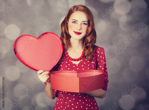 Photo: Redhead girl with gift for Valentines Day. Redhead girl with gift for Valentines Day.