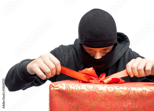 Photo: bandit holding a wrapped Christmas gift bandit holding a wrapped Christmas gift