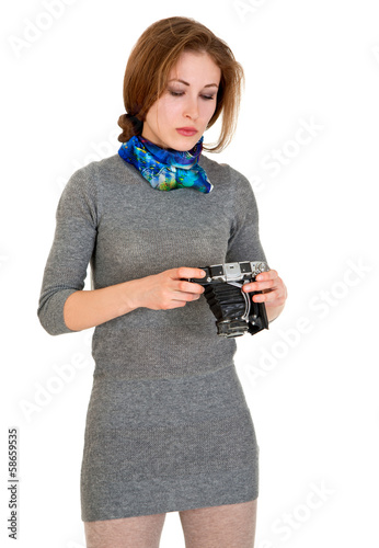 Photo: young girl is looking vintage camera young girl is looking vintage camera