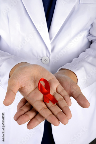Photo: Doctor Hand Holding Red Ribbon Doctor Hand Holding Red Ribbon