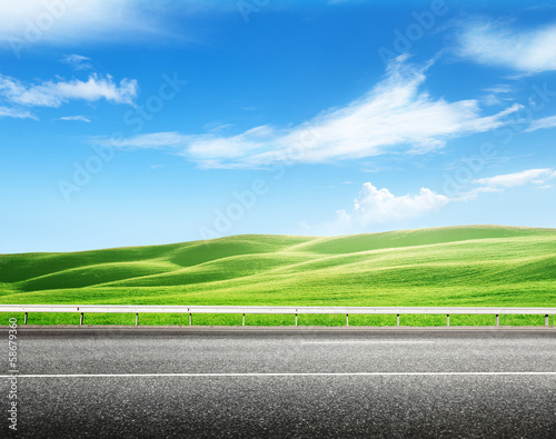 Photo: asphalt road and perfect green field asphalt road and perfect green field