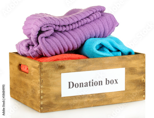 Photo: Donation box with clothing isolated on white Donation box with clothing isolated on white