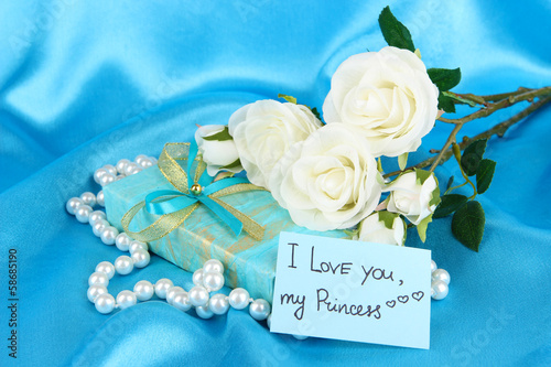 Photo: Romantic parcel on blue cloth background Romantic parcel on blue cloth background