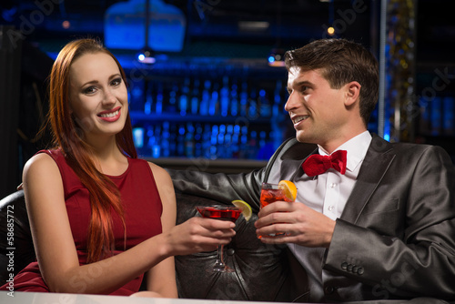Photo: Young couple talking in a nightclub Young couple talking in a nightclub