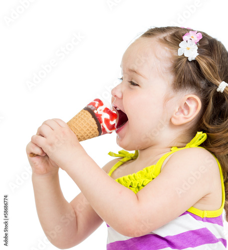 Photo: funny kid girl eating ice cream isolated funny kid girl eating ice cream isolated