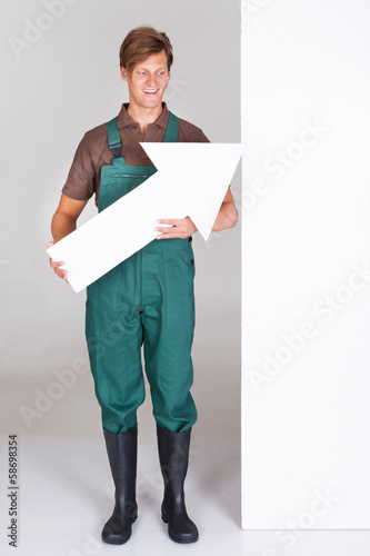 Photo: Male Gardener Presenting Blank Placard Male Gardener Presenting Blank Placard