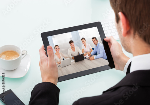 Photo: Businessman Holding Digital Tablet Businessman Holding Digital Tablet