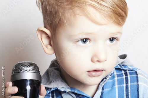 Photo: little boy singing in microphone.child in karaoke.music little boy singing in microphone.child in karaoke.music