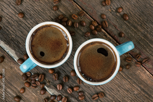 two cups of coffee on wooden table