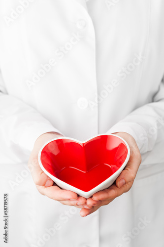 Photo: red heart shape in hands red heart shape in hands