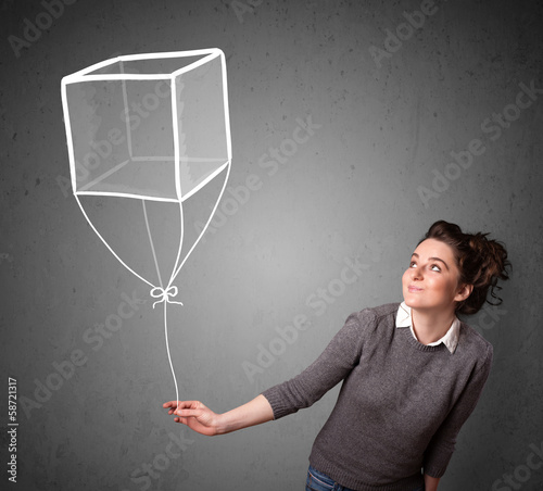 Photo: Woman holding a cube balloon Woman holding a cube balloon