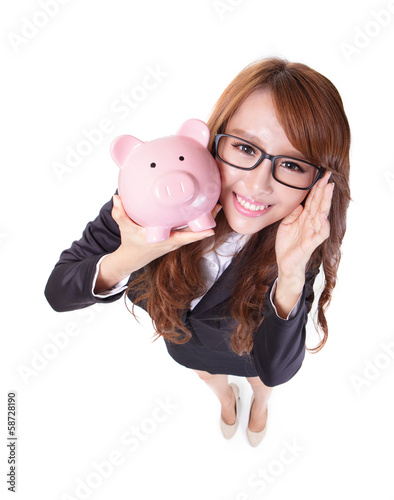 Photo: Piggy bank savings woman smiling happy Piggy bank savings woman smiling happy