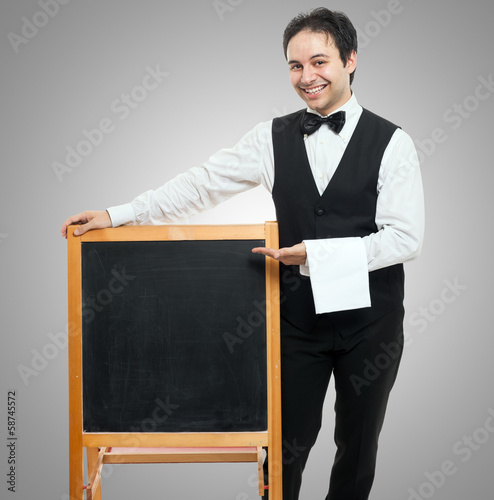 Photo: Waiter showing a blackboard Waiter showing a blackboard
