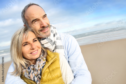 Photo: Senior couple enjoying peaceful time at the beach Senior couple enjoying peaceful time at the beach