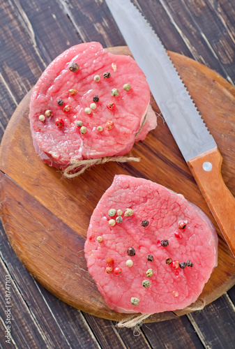 Photo: raw meat and spice on board raw meat and spice on board