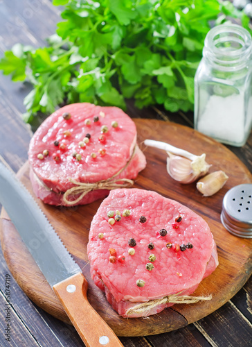 Photo: raw meat and spice on board raw meat and spice on board