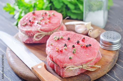 Photo: raw meat and spice on board raw meat and spice on board