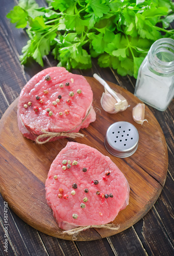 Photo: raw meat and spice on board raw meat and spice on board