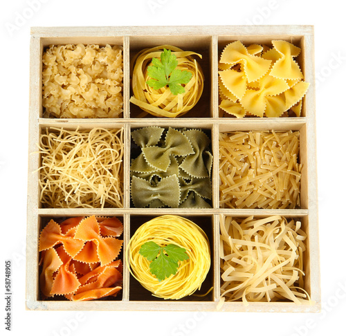 Photo: Nine types of pasta in wooden box sections close-up isolated Nine types of pasta in wooden box sections close-up isolated