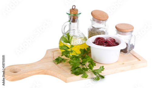 Photo: Raw liver in bowl with spices and condiments isolated on white Raw liver in bowl with spices and condiments isolated on white