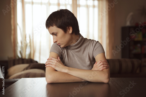 Photo: Pretty shorthair girl sitting at the table Pretty shorthair girl sitting at the table