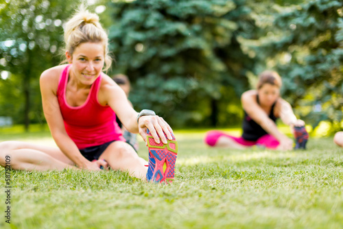 Photo: young woman stetching before a jog young woman stetching before a jog