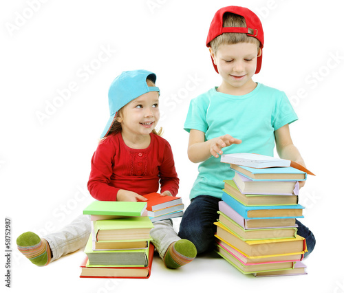 Photo: Little children with books isolated on white Little children with books isolated on white