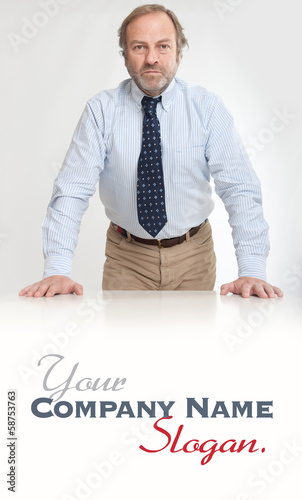 Photo: Serious man leaning on a desk Serious man leaning on a desk