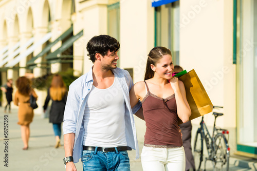 Photo: Couple shopping and spending money in city Couple shopping and spending money in city