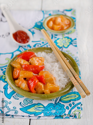 Photo: Chicken with pineapple on the wood background Chicken with pineapple on the wood background