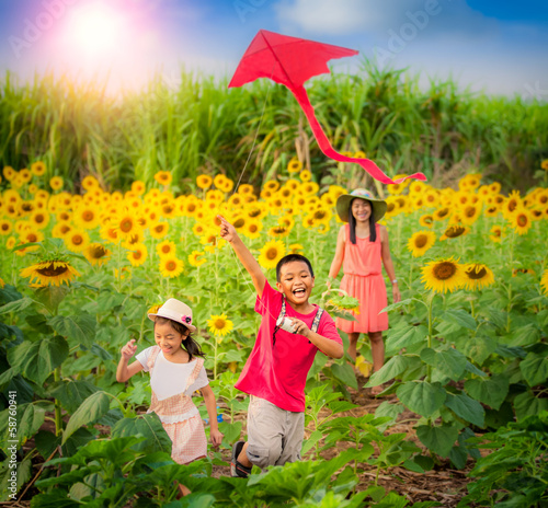 Photo: mother and son in summer playing with kite mother and son in summer playing with kite