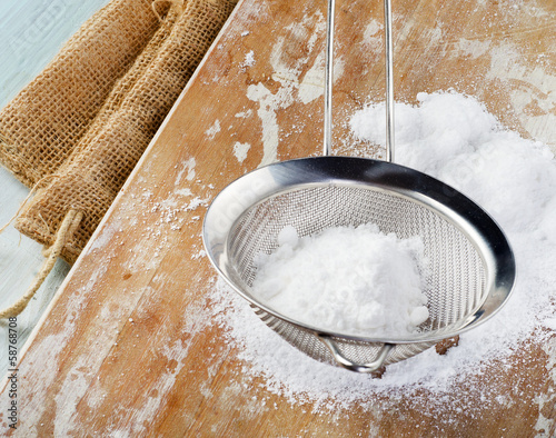 Photo: Powdered sugar in a metal sieve Powdered sugar in a metal sieve