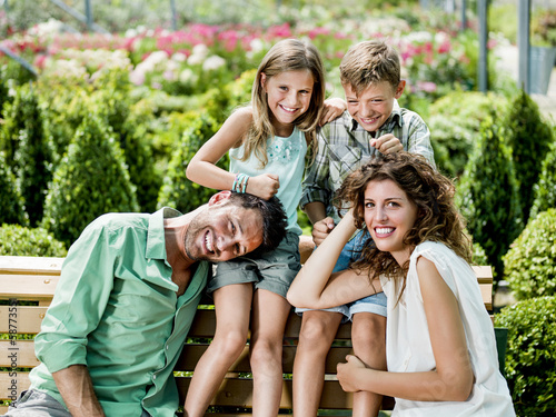 Photo: family having fun in a greenhouse family having fun in a greenhouse