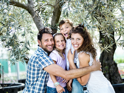 Photo: family having fun with in a greenhouse family having fun with in a greenhouse
