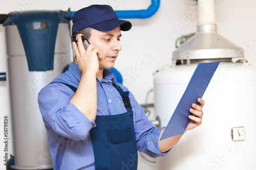 Photo: Plumber talking at the phone Plumber talking at the phone